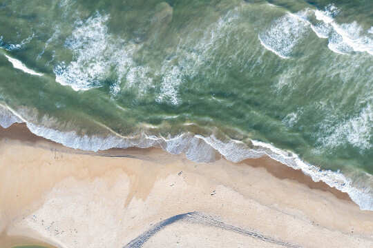 aerial view of waves and beach