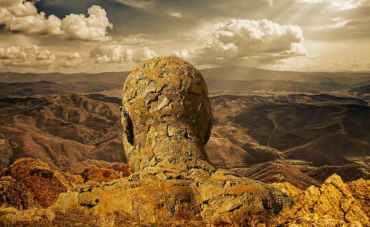 man made of stones, overlooking valley