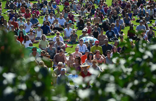People take part in a mass meditation on the lawn of Parliament Hill in Ottawa in 2017.