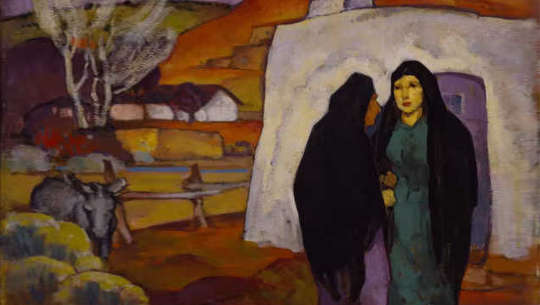 two women standing outside a house
