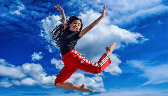young girl jumping for joy