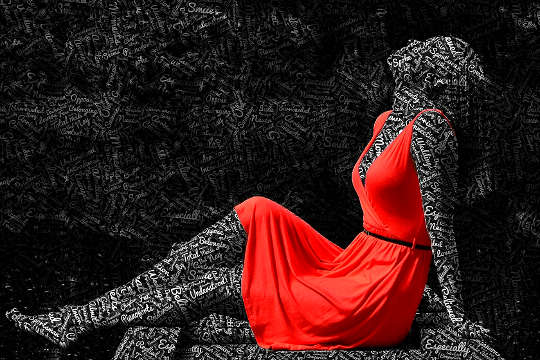 silhouette of a woman in a red dress with word written all over her skin