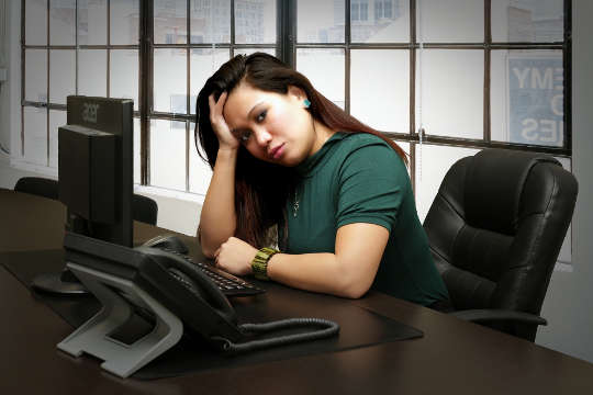 unhappy woman sitting in front of a computer