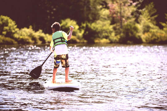 a young boy on a paddleboard