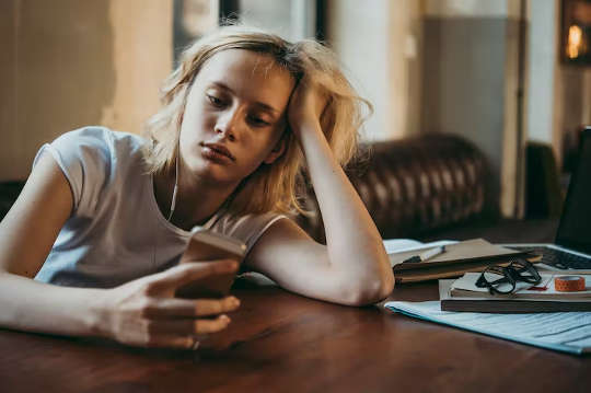 unenergized woman just staring at her phone