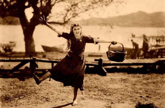 happy woman holding a basket and dancing 