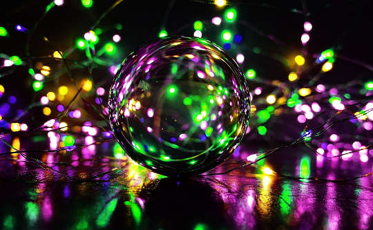 a crystal ball filled with and surrounded by specks of light