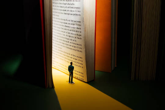 man standing inside of an open book