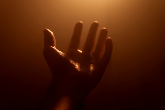 an open hand with light shining down onto it