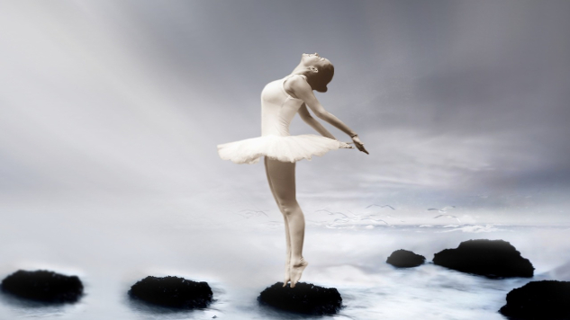 ballerina standing on rocks in water