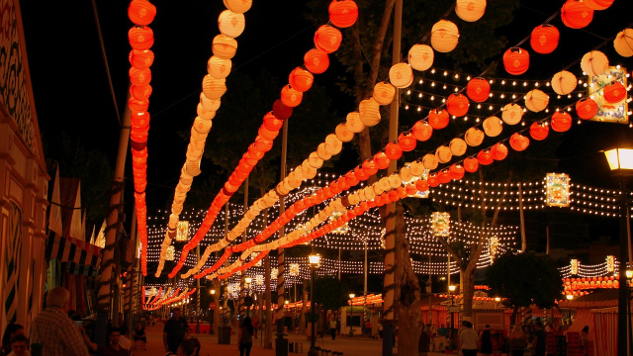 a street lit up with humerous strings of light