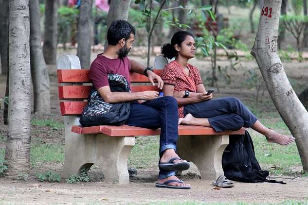 a couple sitting on a bench