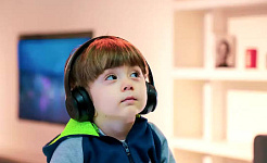 child listening intently wearing headset