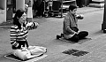 two women meditating on the sidewalk