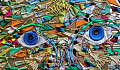 abstract artwork of a face with two blue saucer eyes