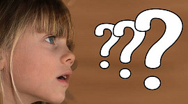 young girl with three huge question marks in front of her