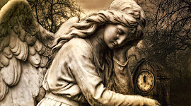 a statue of an angel holding a clock, with a tear falling from its eye