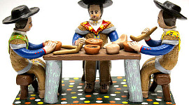 clay figurines sitting at a table eating food made of clay