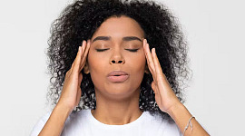 a woman holding her head looking stressed