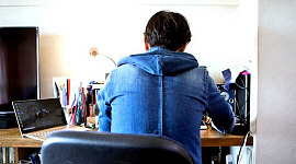 back of person sitting at desk